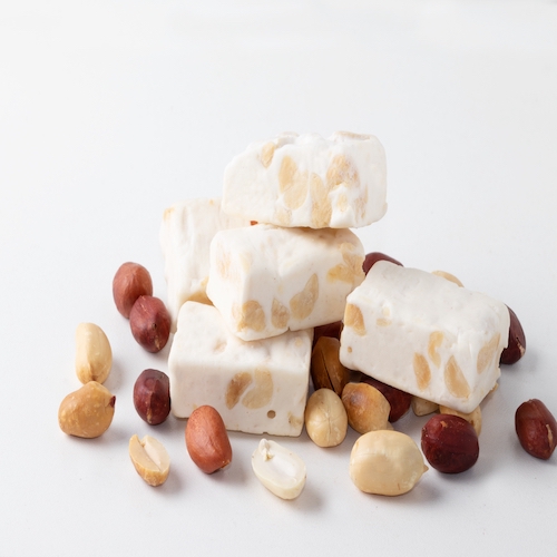 Mini nougats with peanuts. Copy space